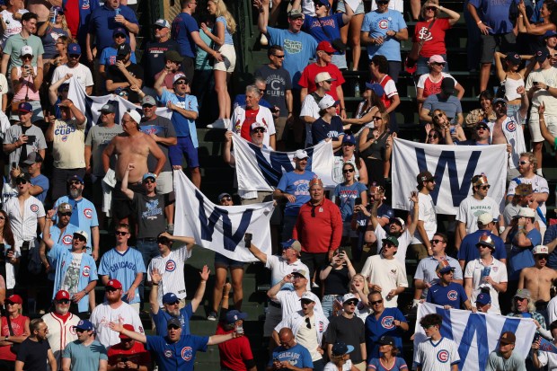 Cubs fans celebrate a 7-3 win over the Cardinals at Wrigley Field on Sept. 27, 2025, in Chicago. (John J. Kim/Chicago Tribune)