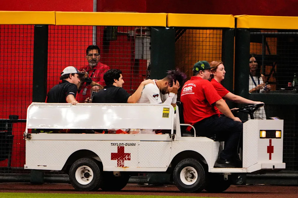 Arizona Diamondbacks outfielder Lourdes Gurriel Jr. (12) is taken off by cart after a collision in the outfield in the sixth inning during the game between the Texas Rangers and Arizona Diamondbacks at Chase Field on Sept. 1, 2025, in Phoenix.