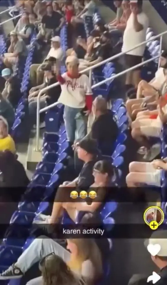 A Phillies fan giving the middle finger to the crowd.
