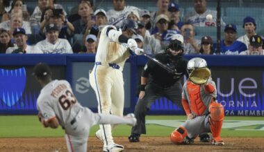 Los Angeles Dodgers' Shohei Ohtani, second from left, heads hits a solo home run as San Francisco Giants relief pitcher Joel Peguero, left, and catcher Patrick Bailey watch during the sixth inning of a baseball game, Saturday, Sept. 20, 2025, in Los Angeles. (AP Photo/Mark J. Terrill)