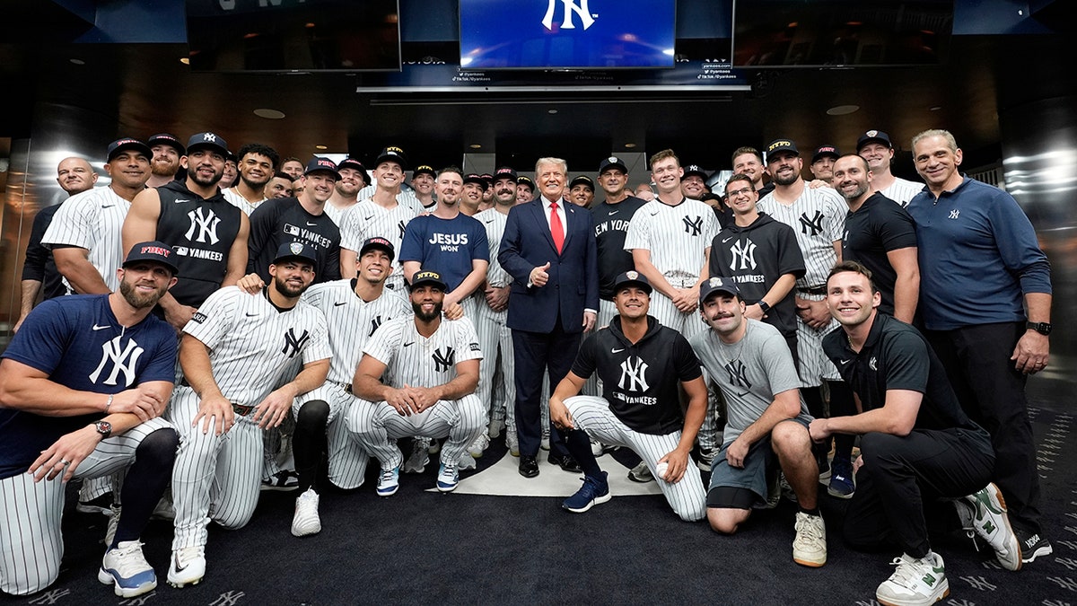 Trump poses for a photo with the Yankees