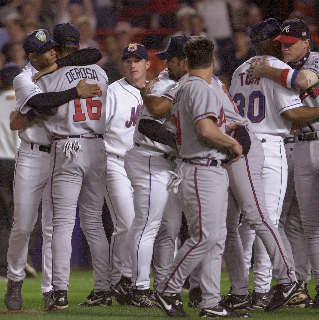 Mets and Braves players exchange hugs on the field at before the Atlanta Braves played the New York Mets at Shea Stadium in New York, NY, Friday night, September 21, 2001, as baseball returns to the Big Apple for the first time since Terrorist Attacks on the World Trade Center and Pentagon. (Smiley N. Pool/Chronicle) 09/21/01 (Photo by Smiley N. Pool/Houston Chronicle via Getty Images)