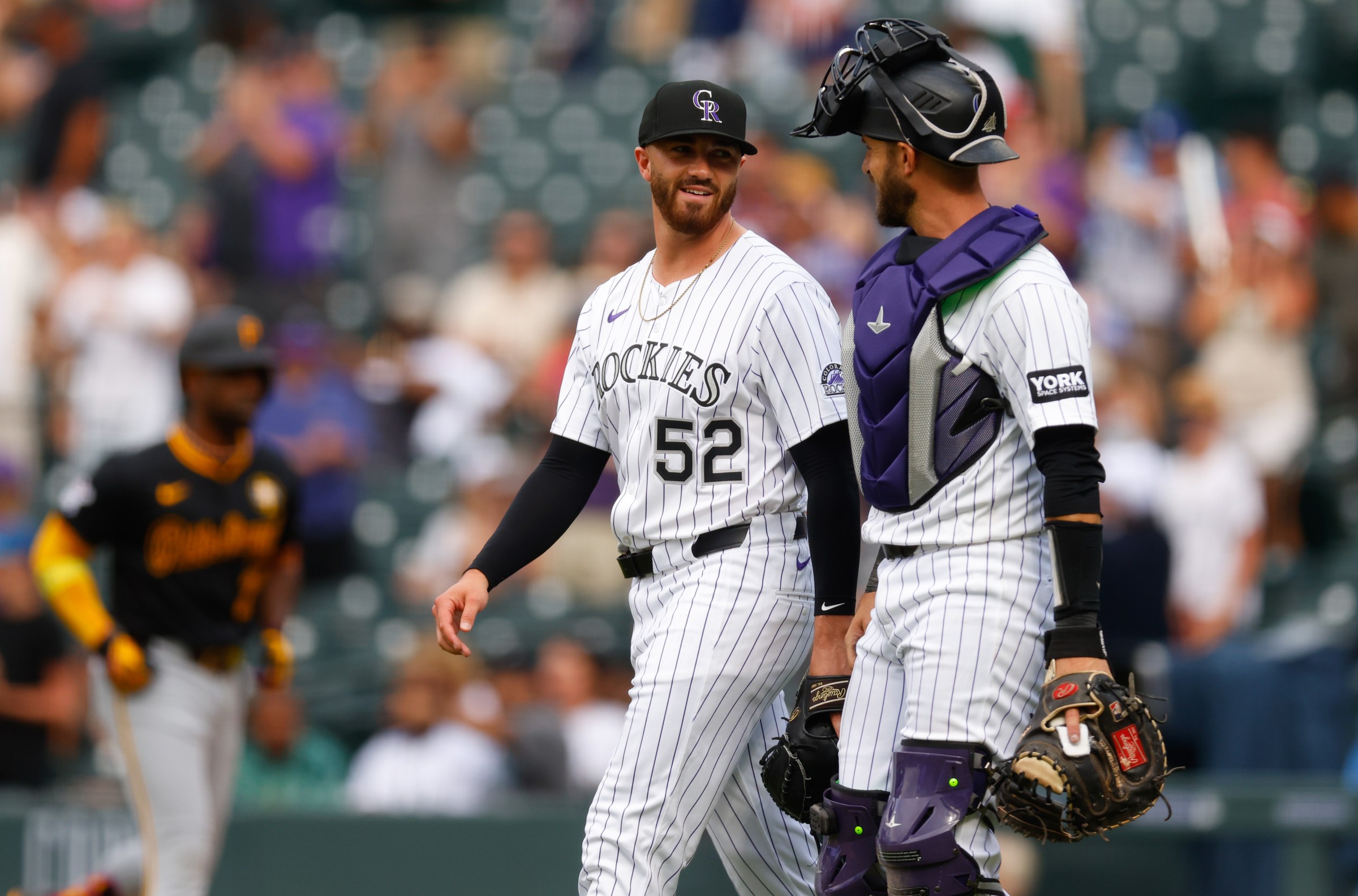 DENVER, CO - AUGUST 2: Dugan Darnell #52 and Austin Nola #20 of the Colorado Rockies celebrate after their 8-5 win to clinch the series against the Pittsburgh Pirates at Coors Field on August 2, 2025 in Denver, Colorado. (Photo by Justin Edmonds/Getty Images)
