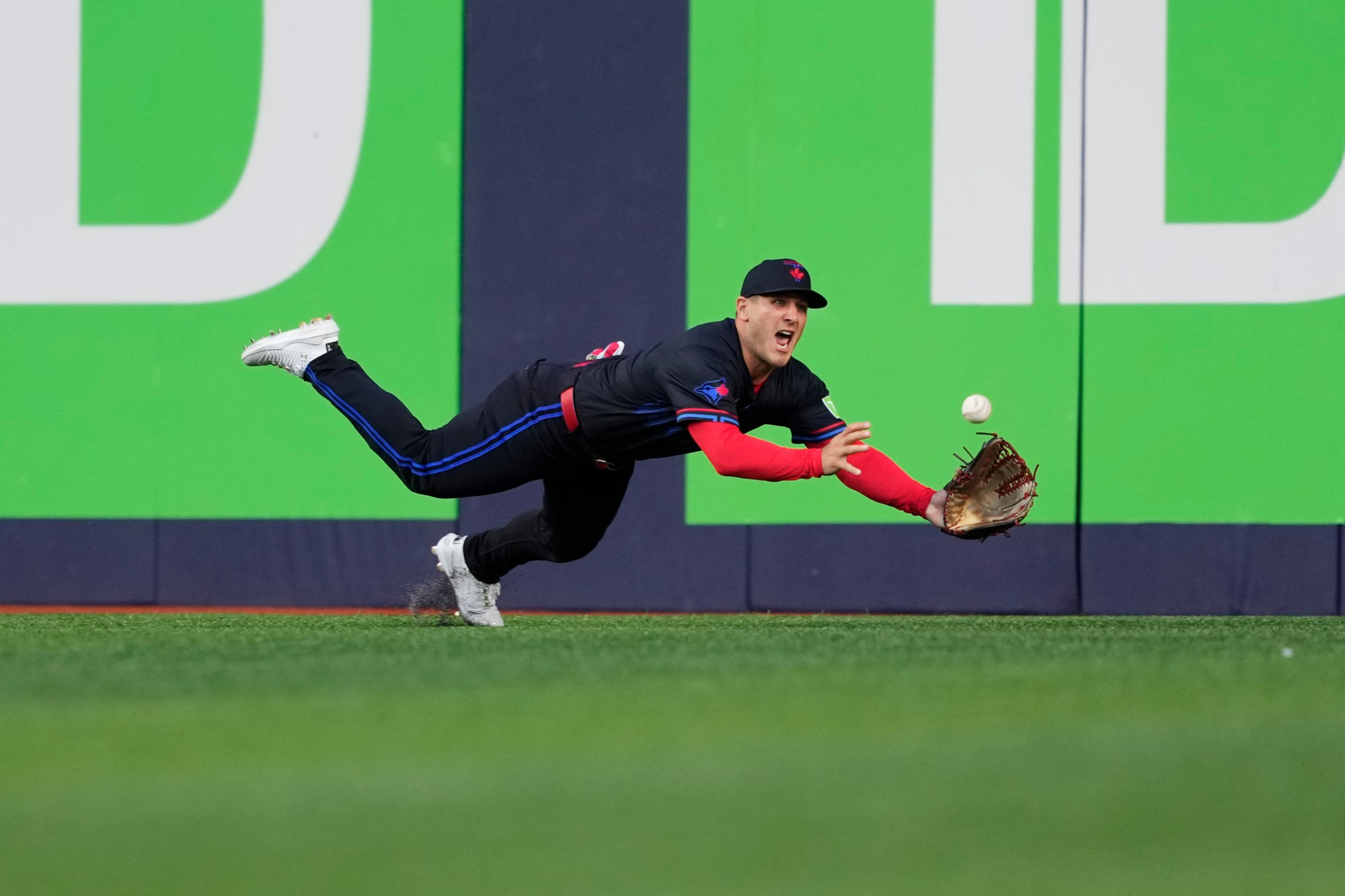 TORONTO, ON - AUGUST 1: Daulton Varsho #25 of the Toronto Blue Jays attempts to makes a diving catch against the Kansas City Royals during the third inning in their MLB game at Rogers Centre on August 1, 2025 in Toronto, Ontario, Canada. (Photo by Mark Blinch/Getty Images)