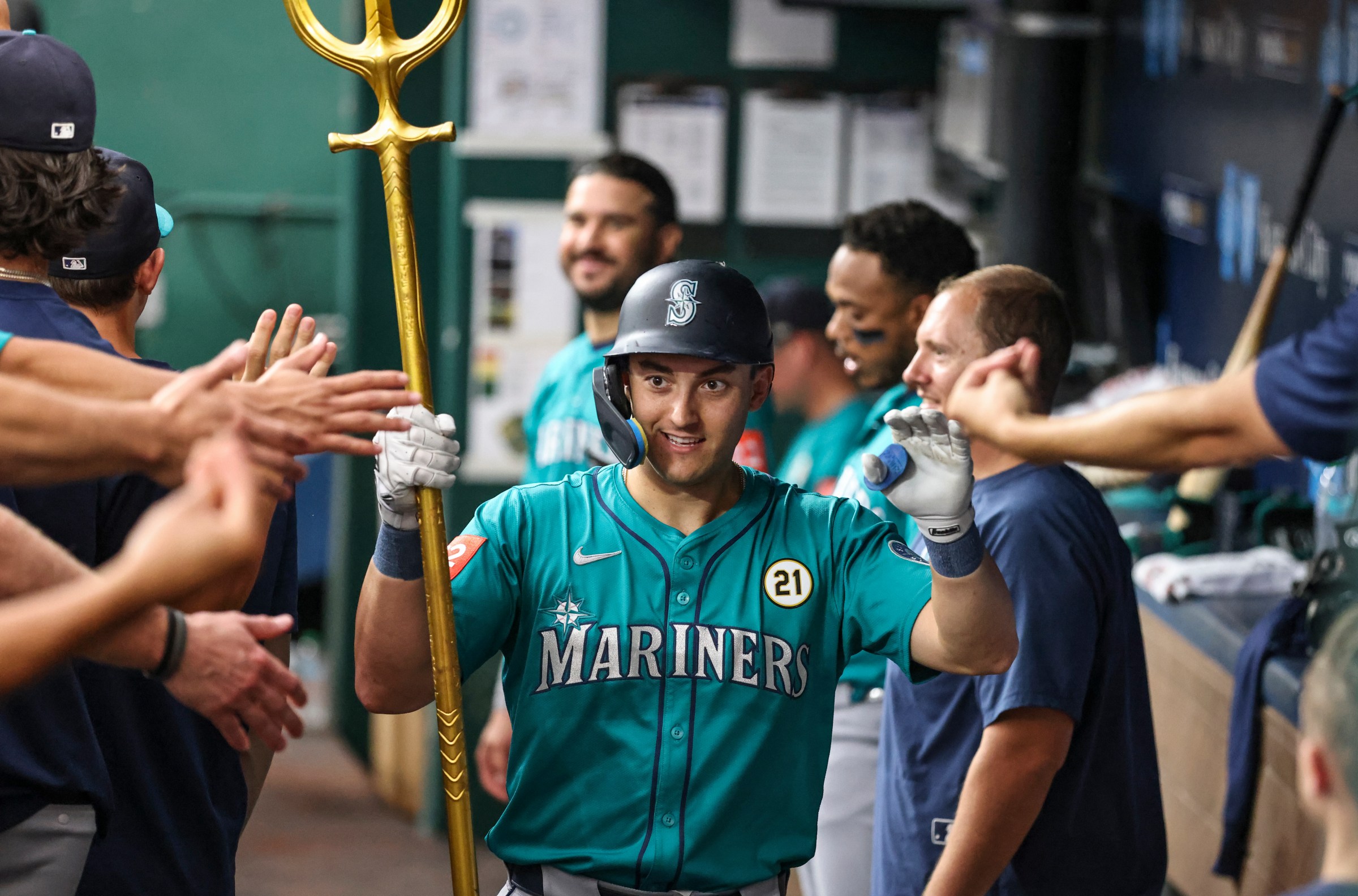 KANSAS CITY, MO - SEPTEMBER 16: Seattle Mariners outfielder Dominic Canzone (8) holds a trident as he is congratulated in the dugout after hitting a home run in the second inning of an MLB game between the Seattle Mariners and Kansas City Royals on September 16, 2025 at Kauffman Stadium in Kansas City, MO. (Photo by Scott Winters/Icon Sportswire via Getty Images)