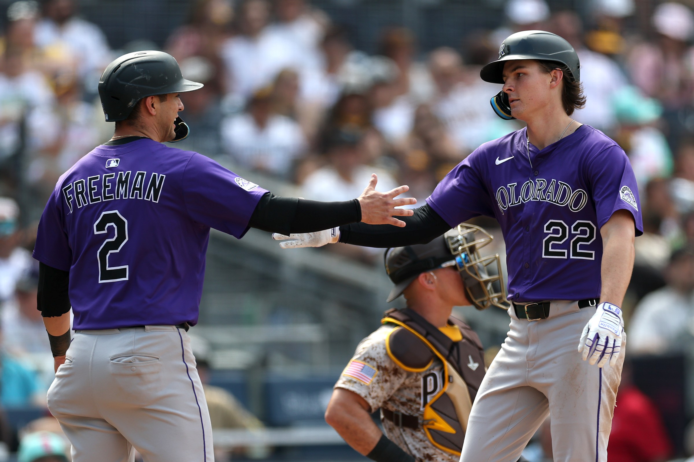 SAN DIEGO, CALIFORNIA - SEPTEMBER 14: Tyler Freeman #2 congratulates Mickey Moniak #22 of the Colorado Rockies after his three run homerun during the sixth inning of a game against the San Diego Padres at Petco Park on September 14, 2025 in San Diego, California. (Photo by Sean M. Haffey/Getty Images)