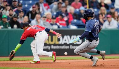 Tampa Bay Rays' Junior Caminero (13) advances to third base behind Cleveland Guardians third baseman Jose Ramirez (11) and then scores on a throwing error by catcher Bo Naylor in the fourth inning of a baseball game in Cleveland, Monday, Aug. 25, 2025. (AP Photo/Sue Ogrocki)