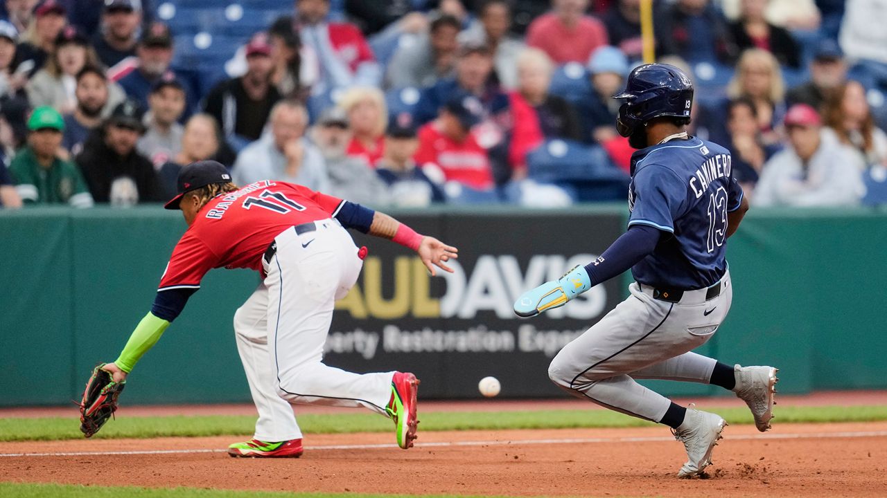 Tampa Bay Rays' Junior Caminero (13) advances to third base behind Cleveland Guardians third baseman Jose Ramirez (11) and then scores on a throwing error by catcher Bo Naylor in the fourth inning of a baseball game in Cleveland, Monday, Aug. 25, 2025. (AP Photo/Sue Ogrocki)