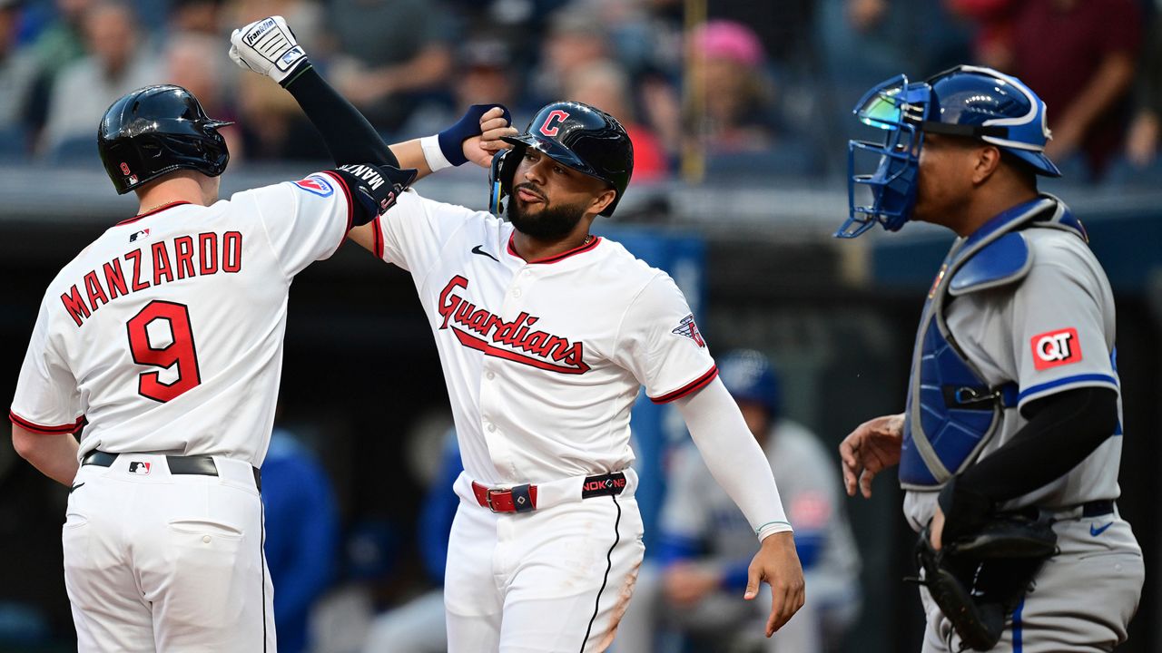 Cleveland Guardians' Kyle Manzardo (9) is congratulated by George Valera, center, after hitting a two-run home run off Kansas City Royals pitcher Jonathan Bowlan during the first inning of a baseball game, Wednesday, Sept. 10, 2025, in Cleveland. (AP Photo/David Dermer)