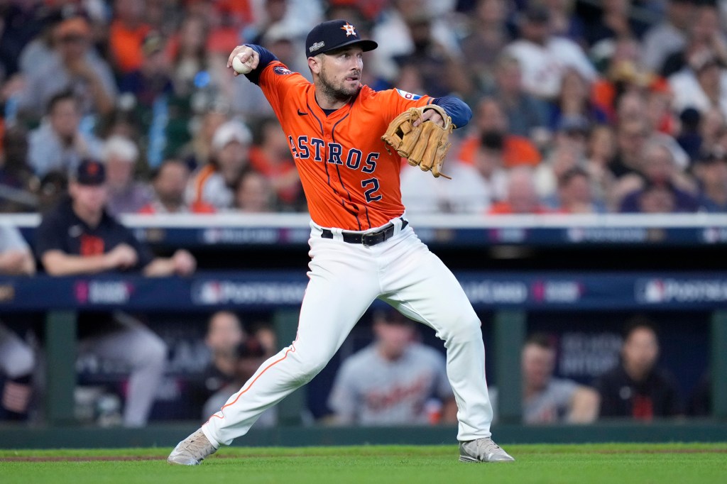 Alex Bregman throws to second after fielding a bunt by Detroit Tigers' Parker Meadows in the ninth inning of Game 2 of an AL Wild Card Series baseball game Wednesday, Oct. 2, 2024, in Houston. 