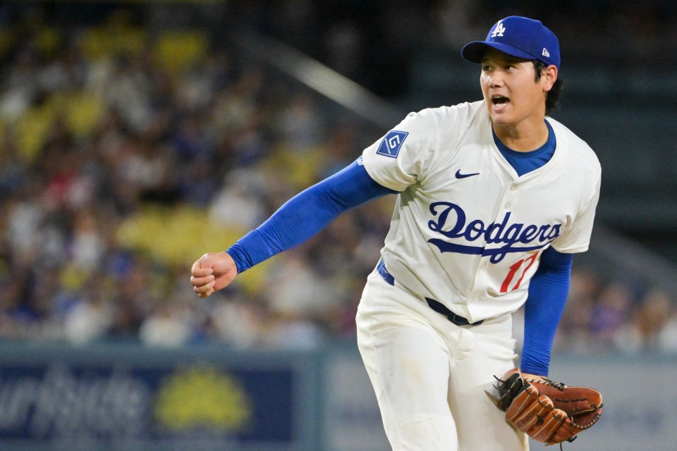 Los Angeles Dodgers player Shohei Ohtani reacts to an umpire's call.