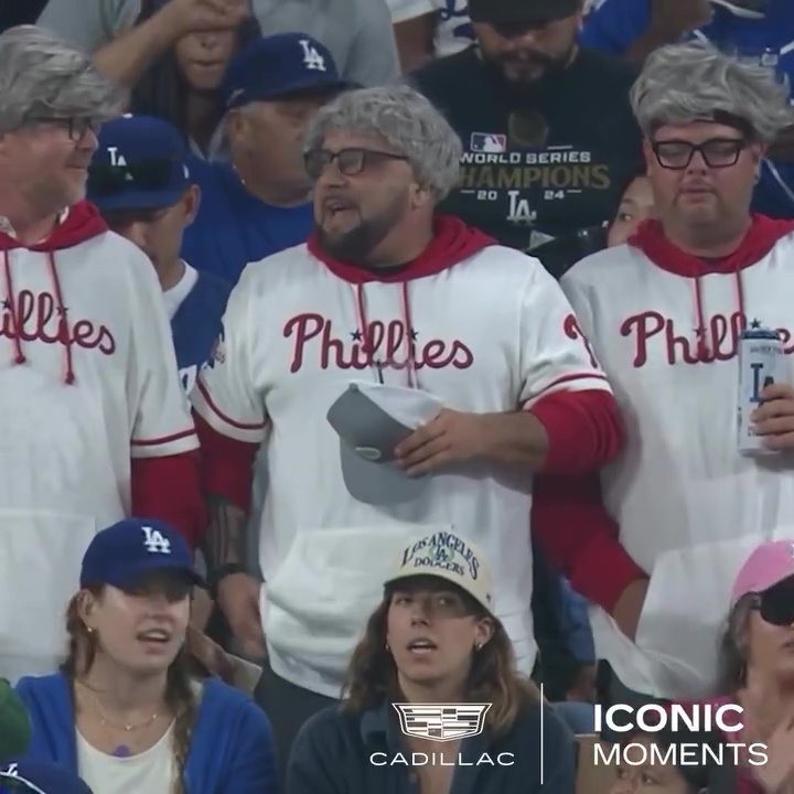 Two men wearing Phillies jerseys and "Karen" wigs are seen at Dodgers Stadium.