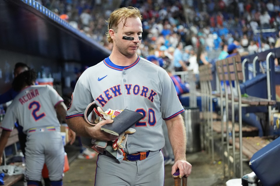 Pete Alonso of the New York Mets gathers his belongings in the dugout.