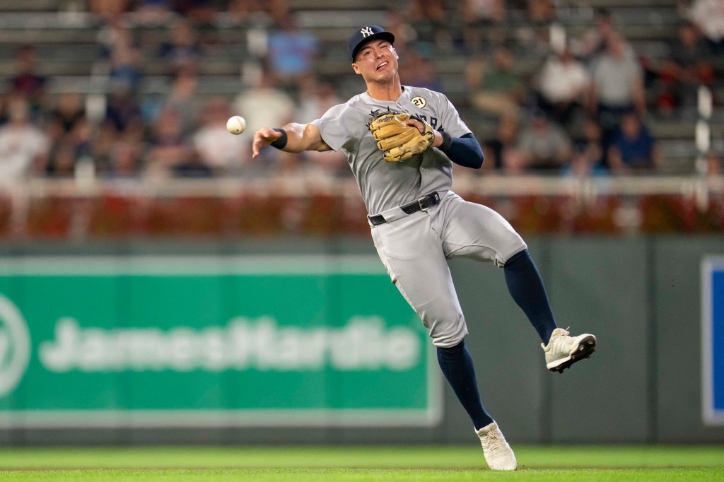 New York Yankees shortstop Anthony Volpe throwing to first base.