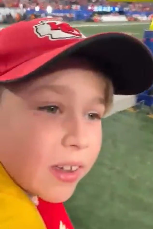 A young boy wearing a red Kansas City Chiefs baseball cap.