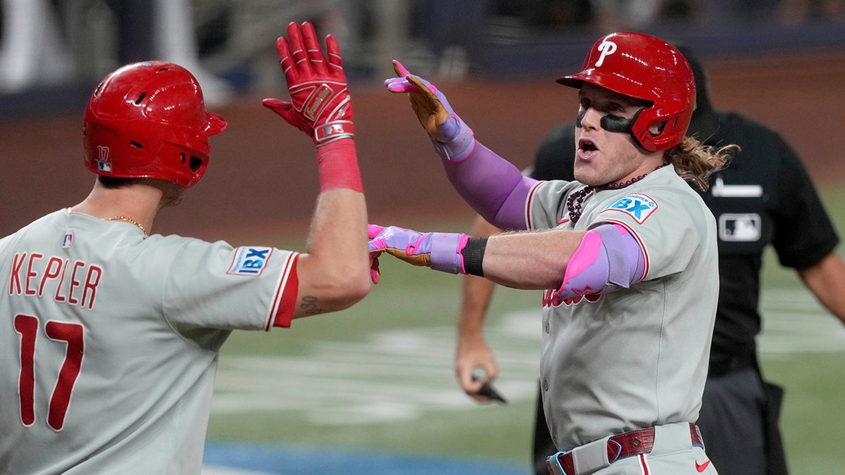 Harrison Bader celebrates with Max Kepler
