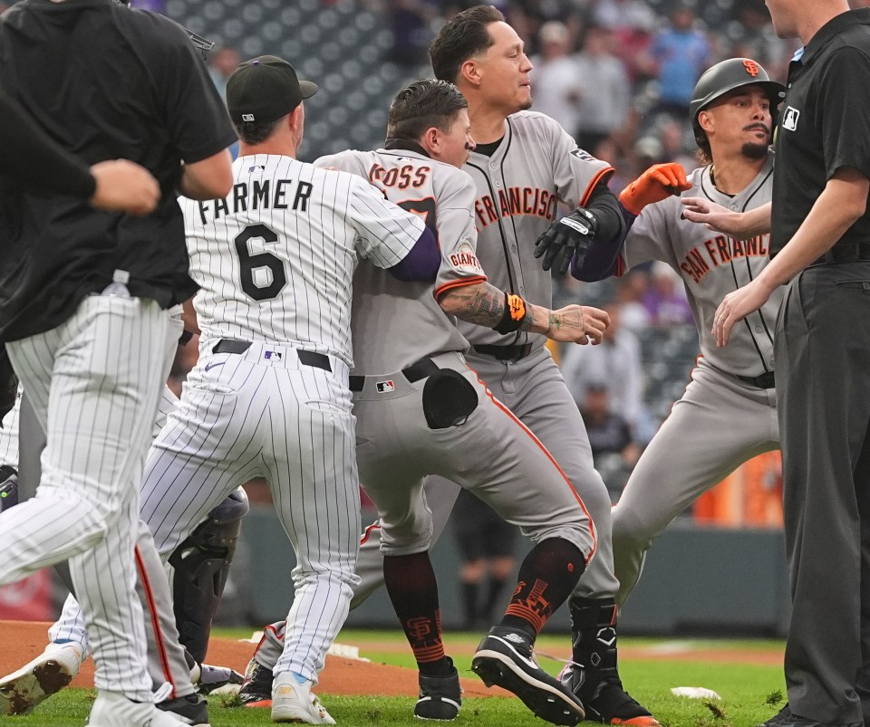 San Francisco Giants players confronting a Colorado Rockies player.