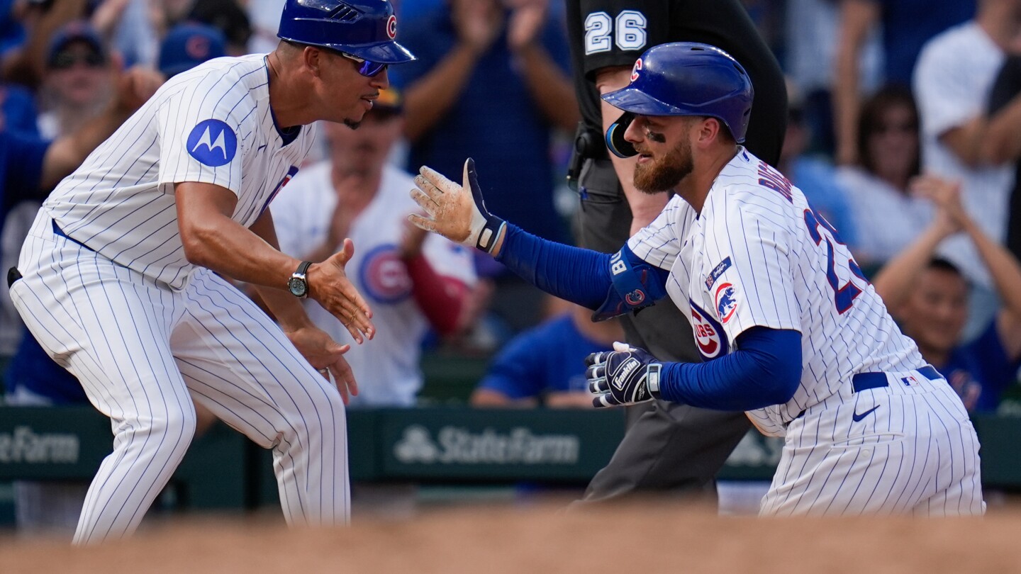 Busch stars as the Cubs beat the Cardinals 7-3 to clinch the top NL wild card