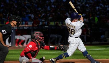 Milwaukee Brewers' Andrew Vaughn hits an RBI double during the fourth inning of a baseball game against the Cincinnati Reds Sunday, Sept. 28, 2025, in Milwaukee.