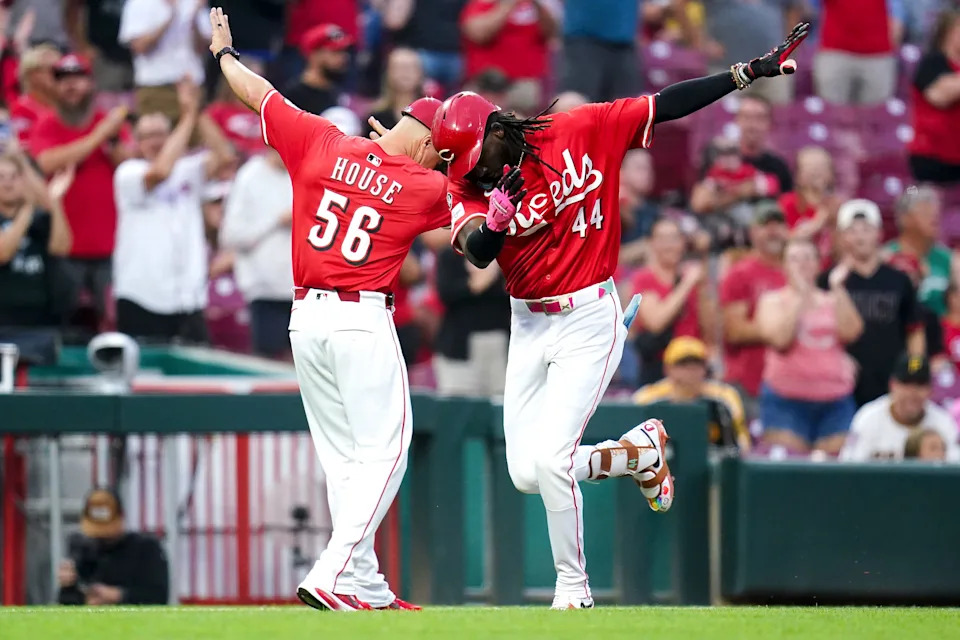 Cincinnati Reds shortstop Elly De La Cruz celebrates a home run with third-base coach JR House