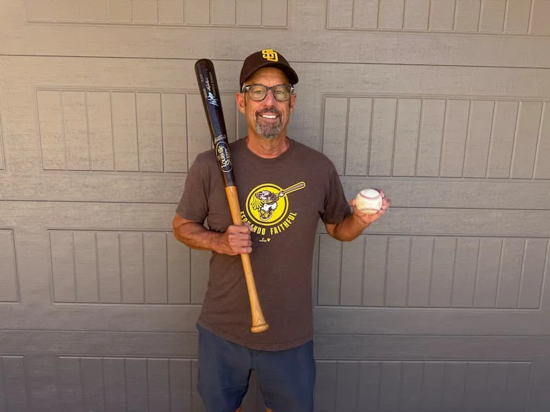 Paul Cooper shows the bat and signed baseball he received from Bo Jackson at the 1989 MLB All-Star Game. | Paul Cooper