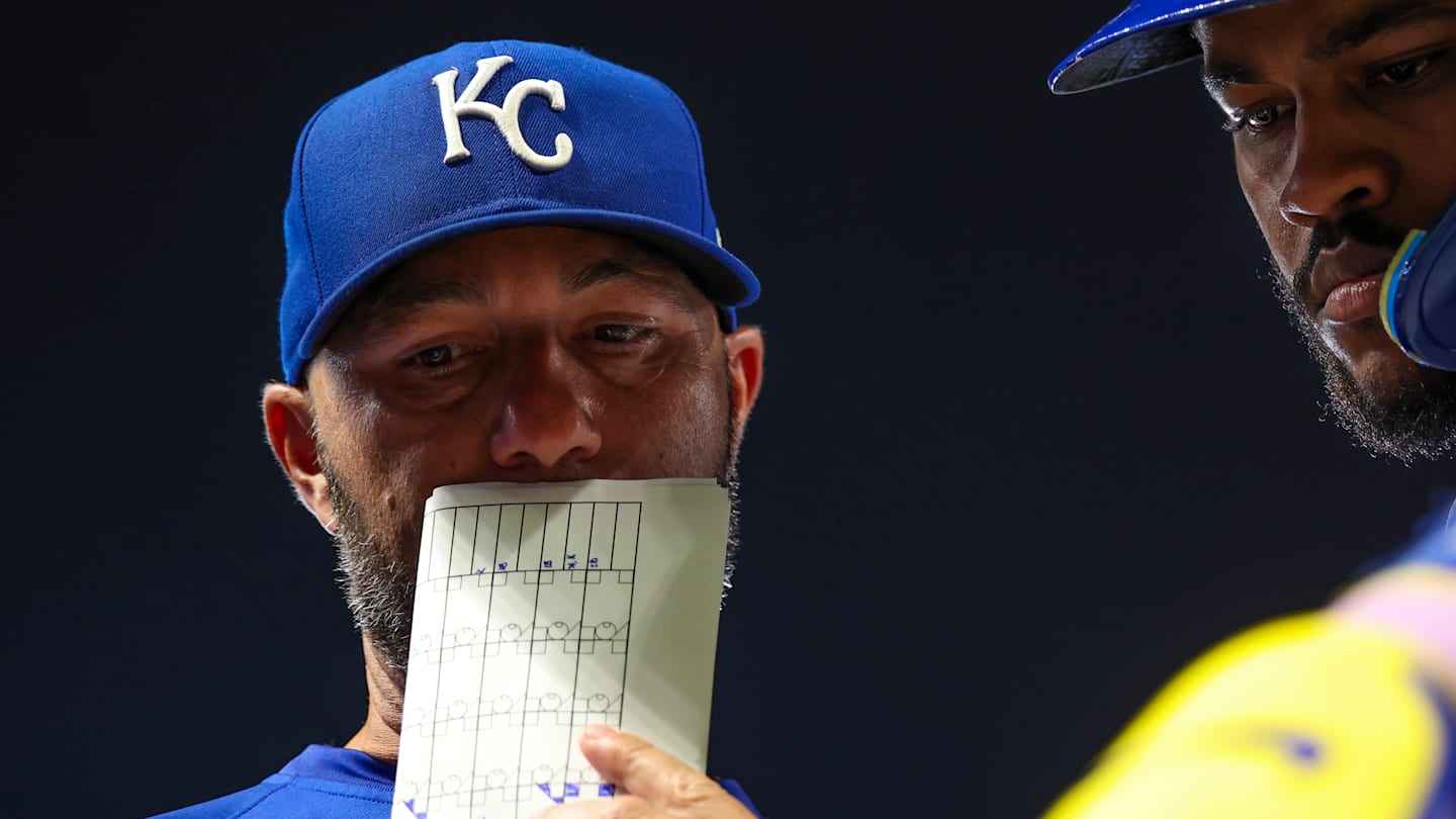 Royals hitting coach Alex Zumwalt goes over strategy with Maikel Garcia during a game against the Minnesota Twins.