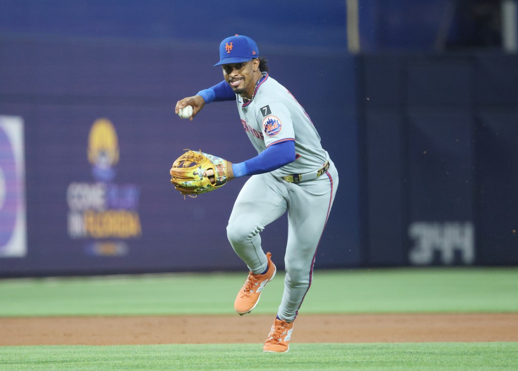 Francisco Lindor #12 of the New York Mets throws out Otto Lopez #6 of the Miami Marlins.