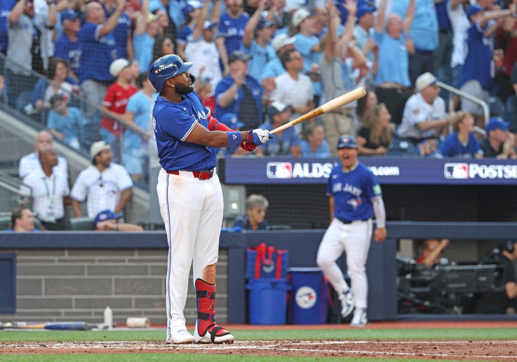 Vladimir Guerrero Jr. watches his grand slam during the fourth inning at a baseball game.