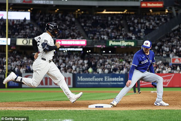 Jeff Hoffman (L) forces out Trent Grisham at first base during the bottom of the ninth inning