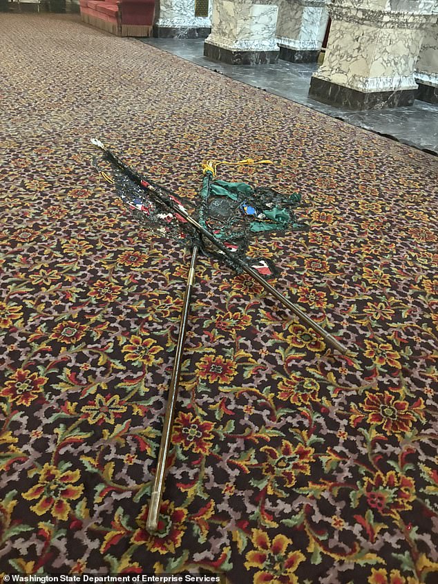 A USA flag was burnt into carpet during his violent rampage at the Capitol on Sunday night