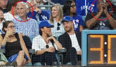 Prince Harry and Meghan Markle were sat in front of Sandy Koufax (L) and Magic Johnson (R)