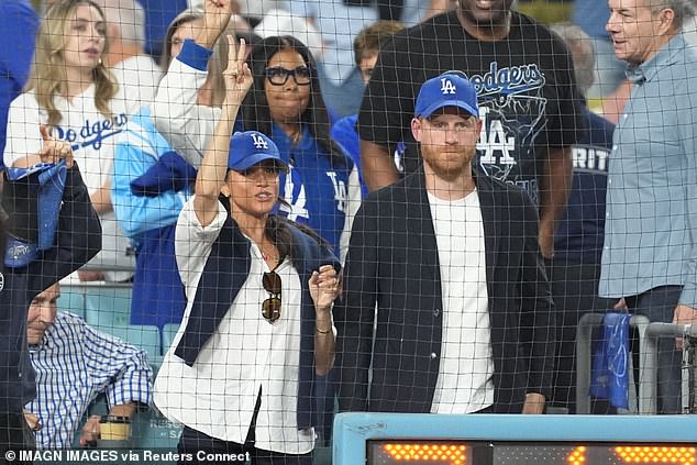 Meghan looked animated as she and Harry cheered for the Dodgers in front of Magic Johnson