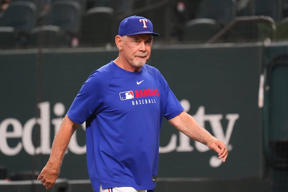 Texas Rangers manager Bruce Bochy walks on the field before a baseball game against the...