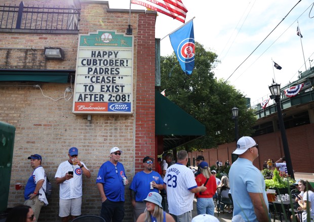Chicago Cubs fans hang out at Murphy’s Bleachers tavern outside...