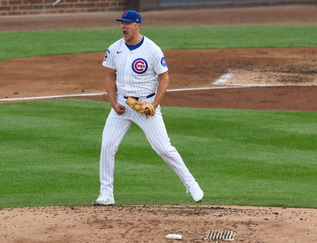 Cubs starting pitcher Jameson Taillon celebrates after getting out all...