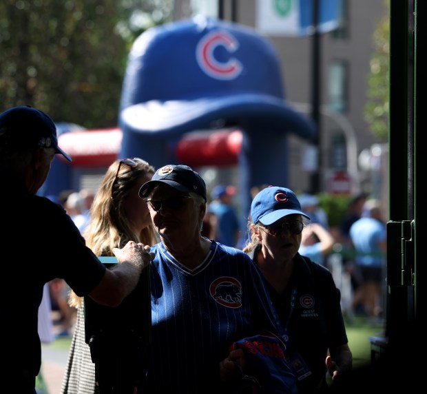 Cubs fans enter Wrigley Field for Game 3 of the...