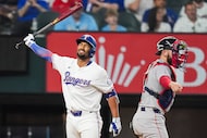 Texas Rangers second baseman Marcus Semien reacts next to Boston Red Sox catcher Connor Wong...