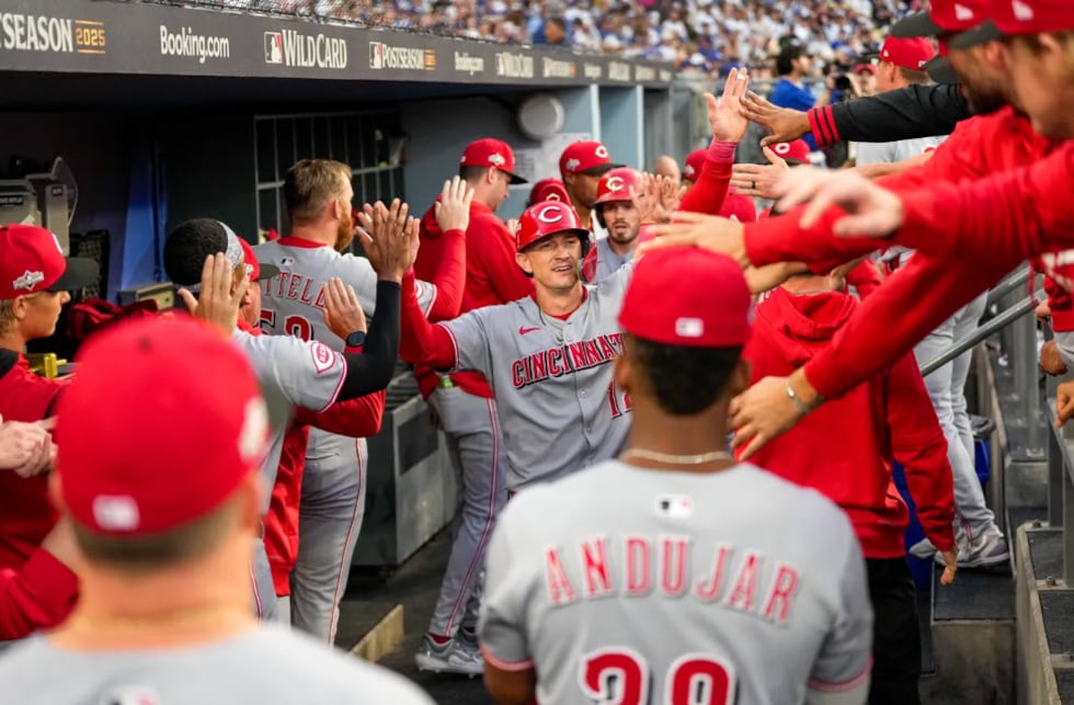 Cincinnati Reds right fielder Austin Hays (12) celebrates after scoring on a two-RBI single...