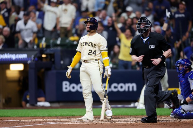 Brewers catcher William Contreras watches his solo homer during the...