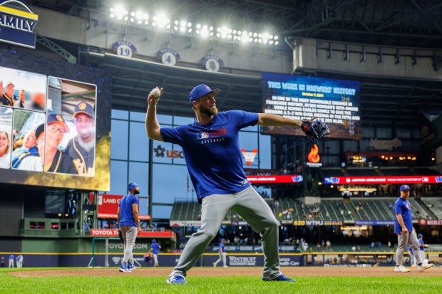 Chicago Cubs first baseman Michael Busch (29) throws on the...