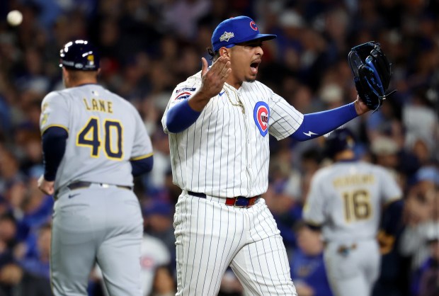 Cubs relief pitcher Daniel Palencia celebrates after closing out the...