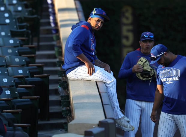 Cubs relief pitcher Daniel Palencia relaxes along the third base...