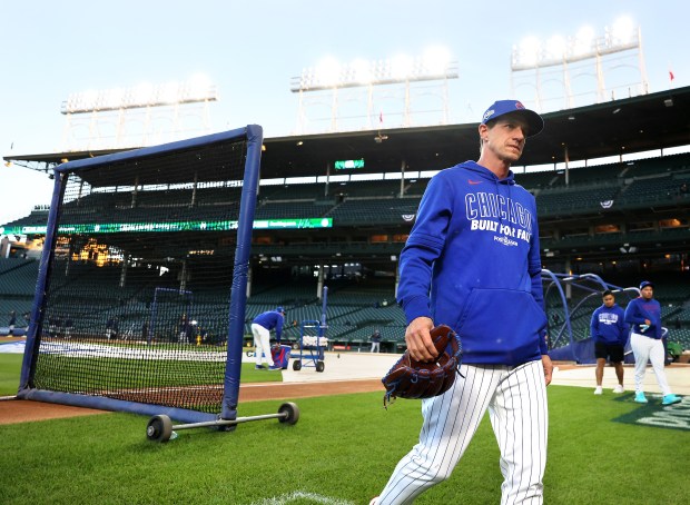Chicago Cubs manager Craig Counsell walks off the field after...