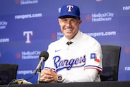 Skip Schumaker, the new manager of the Texas Rangers, answers questions during a news...