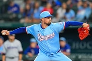 Texas Rangers pitcher Shawn Armstrong throws a pitch during the ninth inning of a baseball...