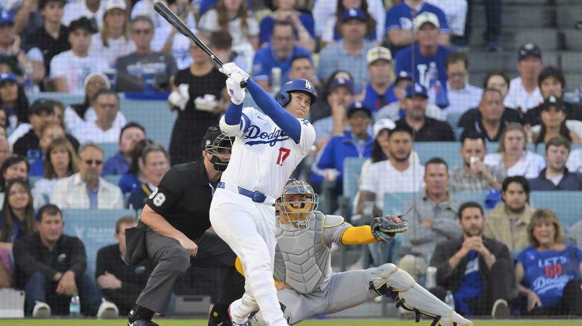 Los Angeles Dodgers two-way player Shohei Ohtani (17) hits a home run against the Milwaukee Brewers during the first inning of game four of the NLCS round for the 2025 MLB playoffs at Dodger Stadium.