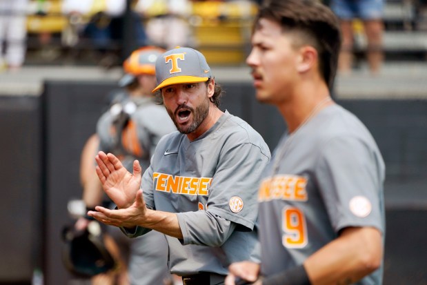 Tennessee coach Tony Vitello, left, cheers on his players in the fifth inning of an NCAA college baseball tournament super regional game against Southern Mississippi, Sunday, June 11, 2023, in Hattiesburg, Miss. The game was a continuation of Saturday's play which was suspended due to weather concerns. (AP Photo/Rogelio V. Solis)