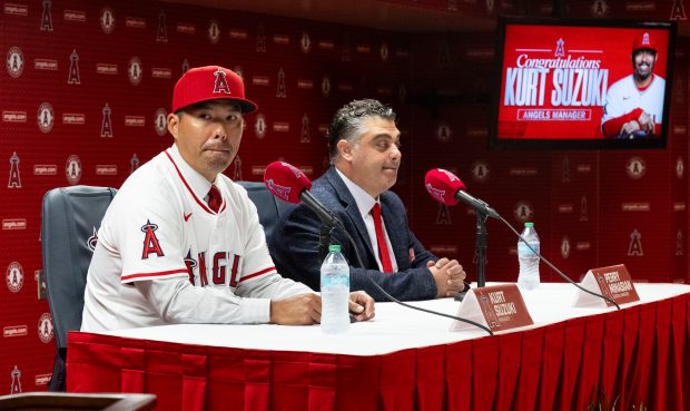 New Angels manager Kurt Suzuki, left, speaks to the media...