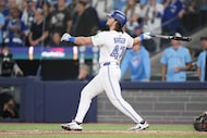 Toronto Blue Jays' Addison Barger watches the ball as he hits a grand slam against the Los...