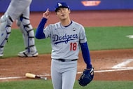 Los Angeles Dodgers' pitcher Yoshinobu Yamamoto celebrates his complete game after Game 2 of...